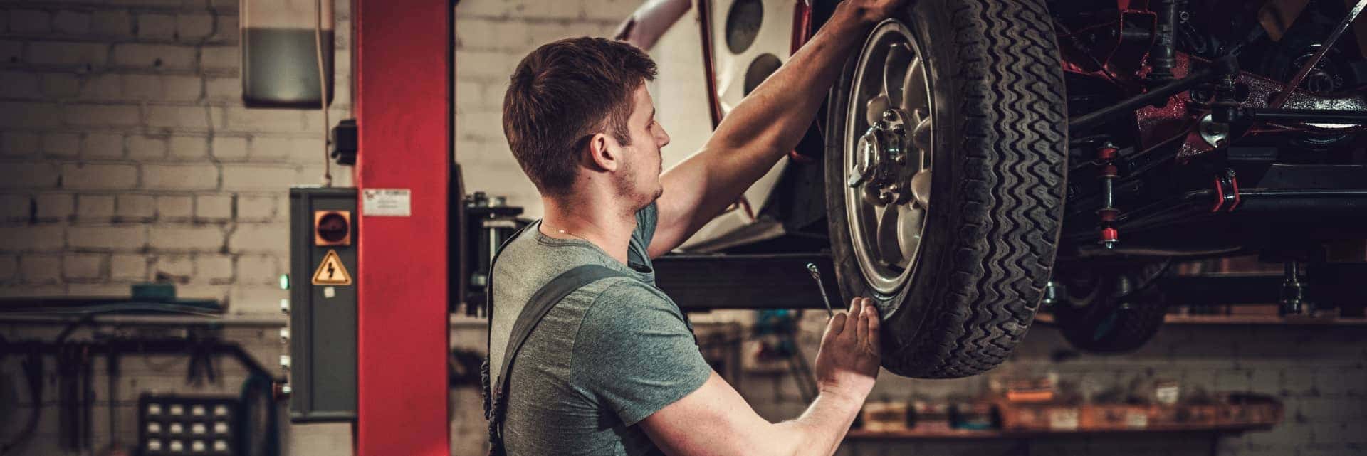 service specialist putting on a new tire