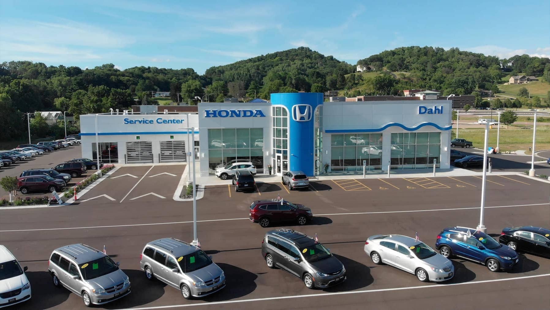 An exterior shot of a Honda dealership during the day.