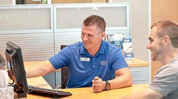 A Hendrick employee helping a customer through financing