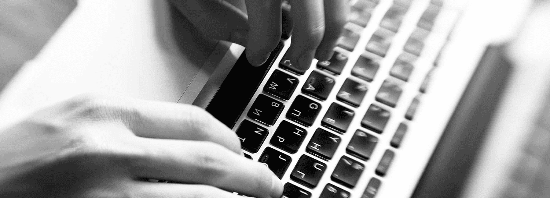 closeup of man typing on keyboard