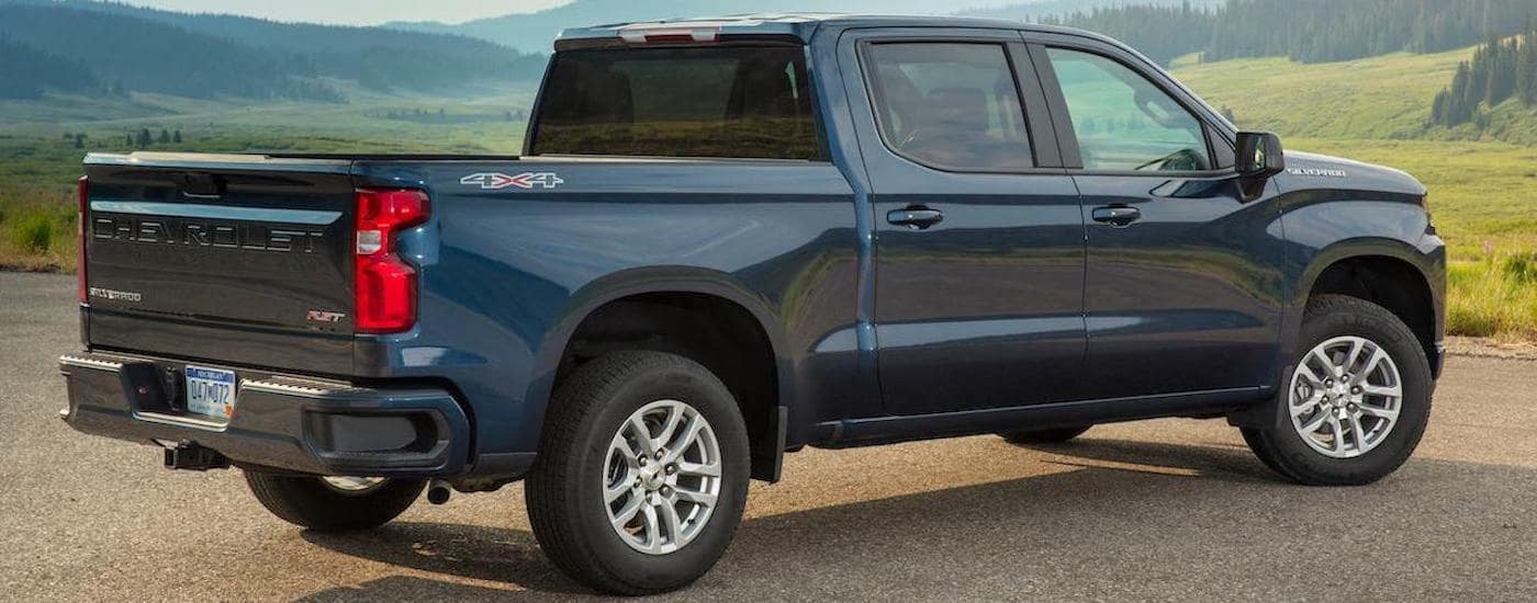 A dark blue 2020 Chevy Silverado RST is overlooking mountains.