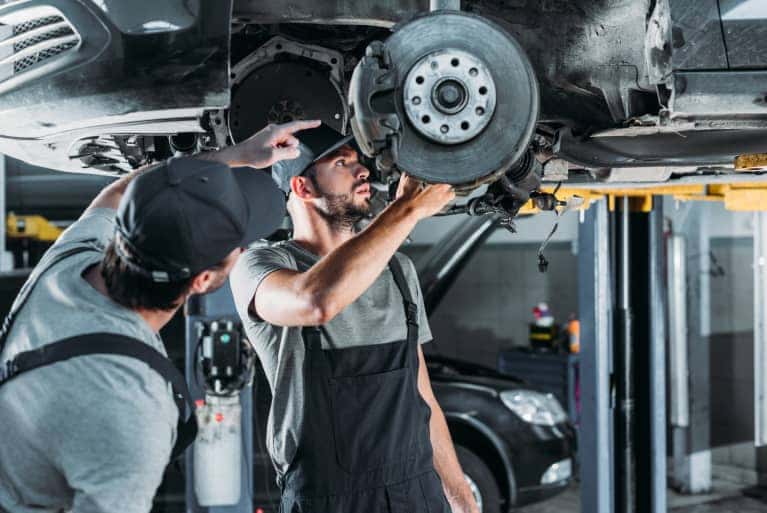 two service specialists looking at brakes
