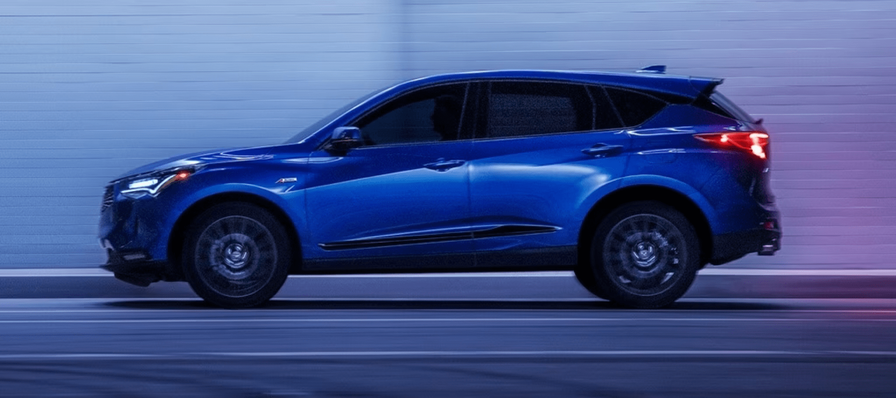 2023-Acura-RDX-Apex-Blue-Pearl-speeds-by