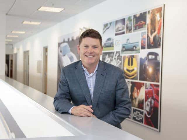 Shaun Del Grande in front of Chevrolet collage