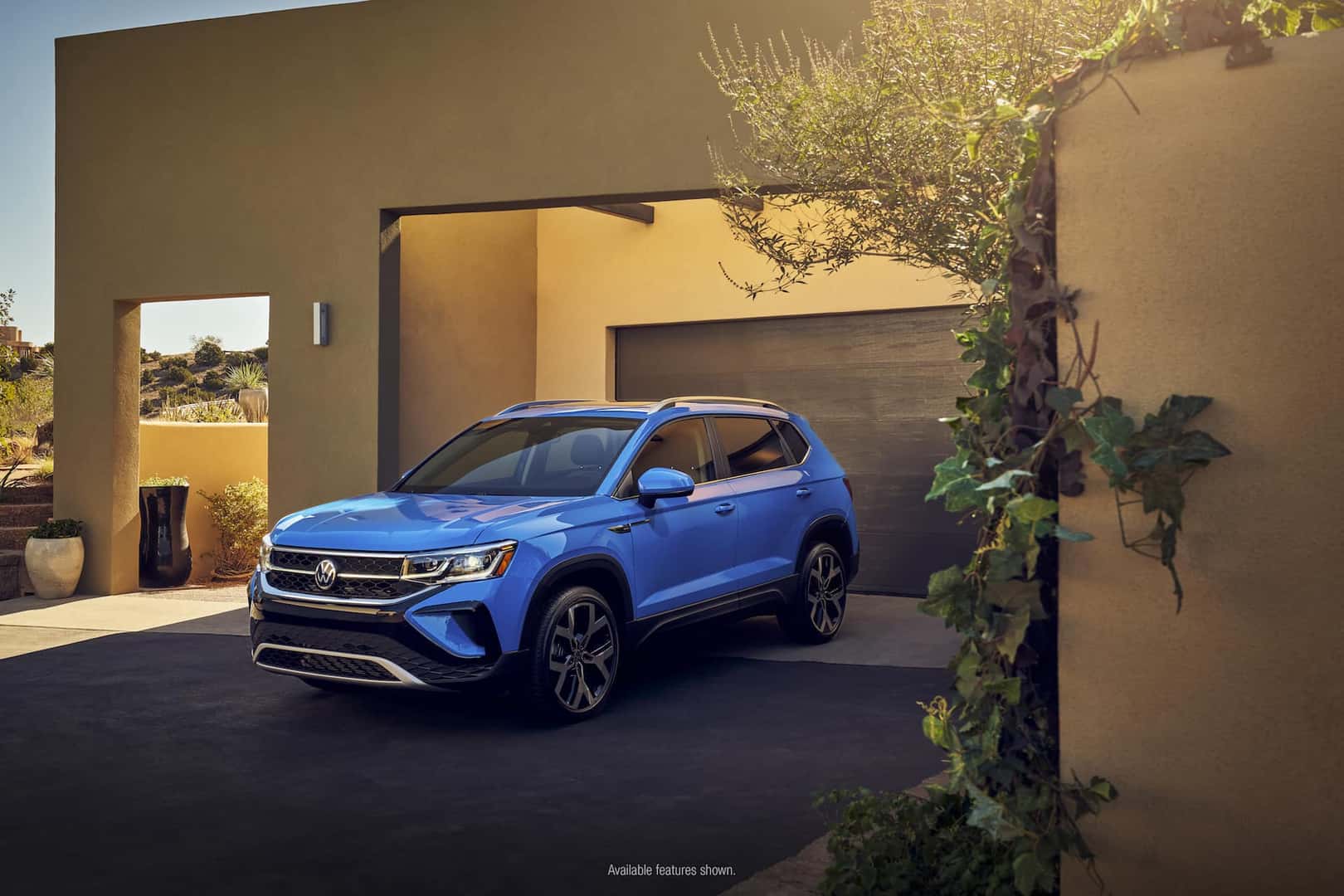 2022 Volkswagen Taos parked in front of a garage