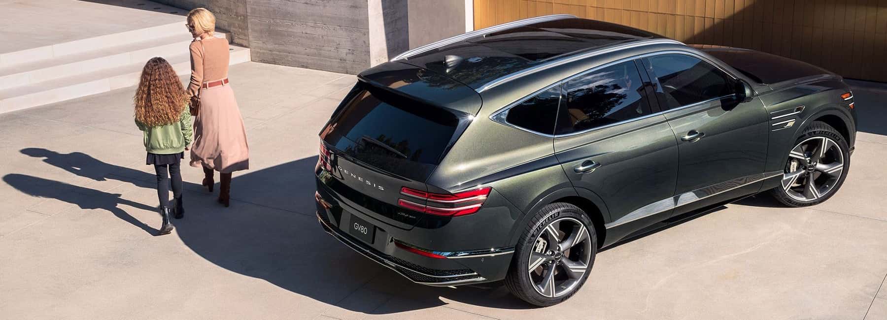 genesis-2025-GR80-parked woman and daughter walk away from car