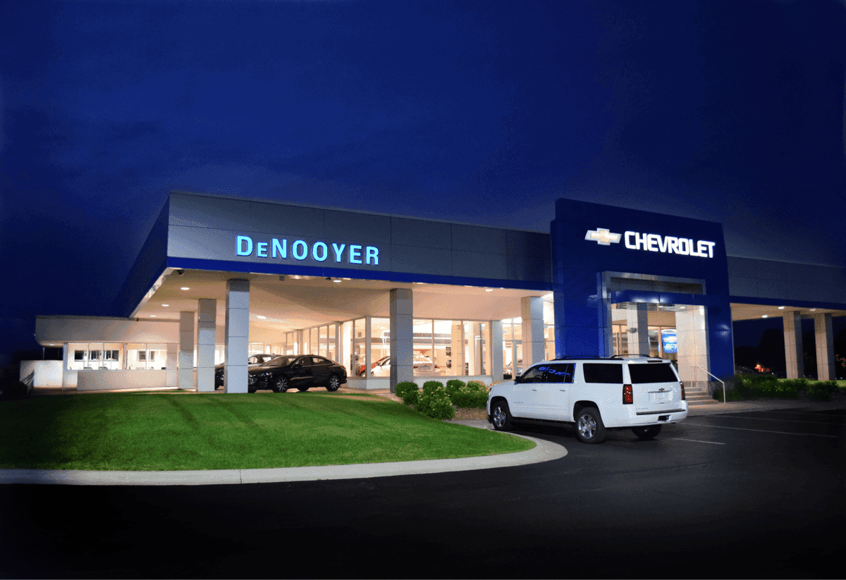 An exterior shot of a Chevrolet dealership at night.