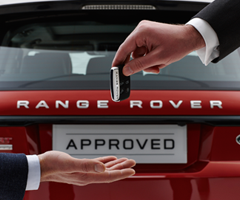 dealer handing over keys for range rover to customer