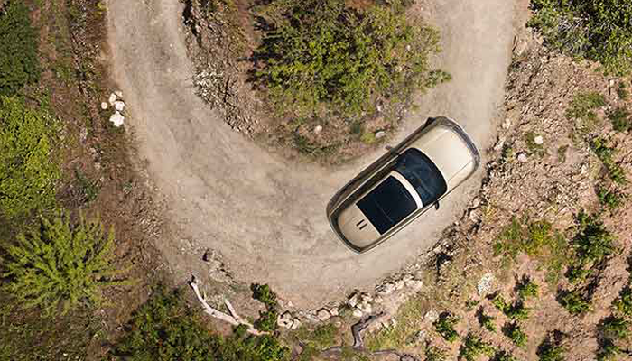 Aerial View of Land Rover Driving on Curvy Road