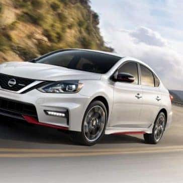 White 2019 Nissan Sentra driving around corner