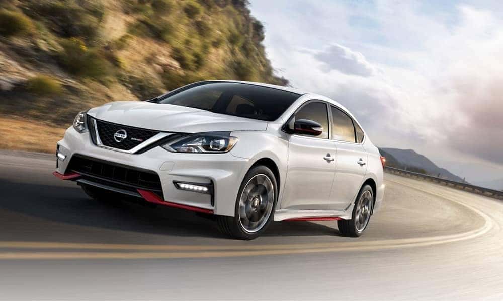 White 2019 Nissan Sentra driving around corner