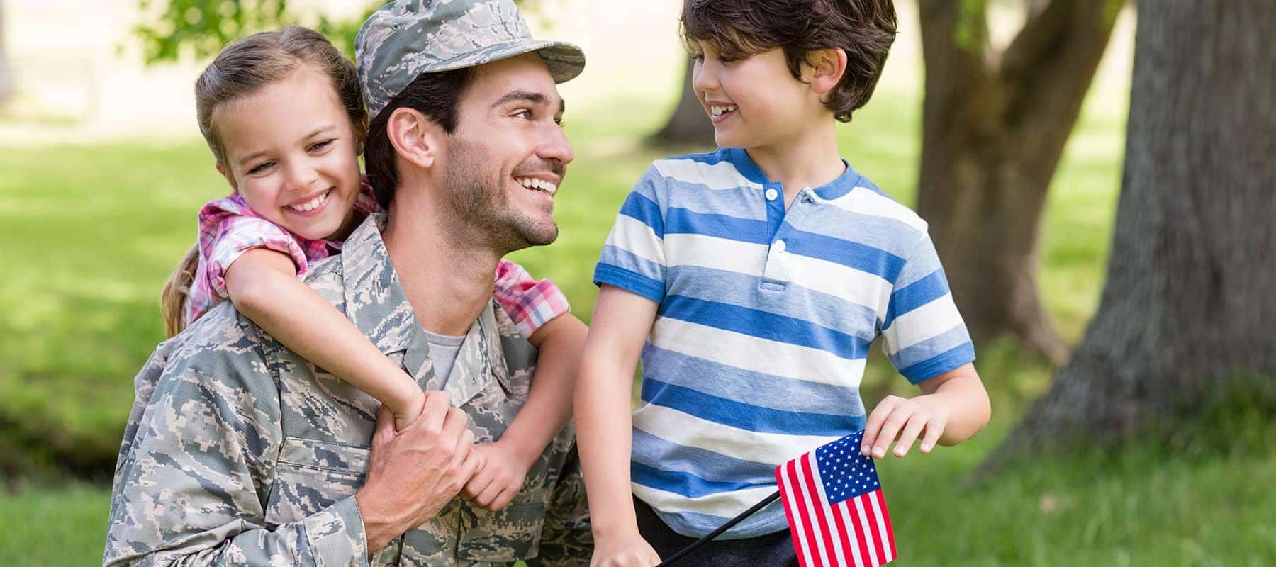 military man receives hug from daughter and smile from son