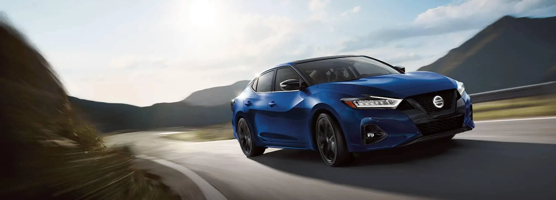 A 2021 Blue Nissan Maxima on the highway