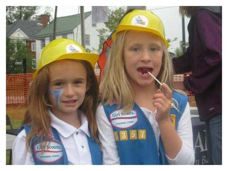 2 Girl scouts wearing hard hats