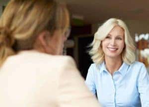 woman is talking with saleswoman