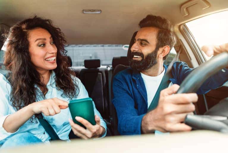 man-and-woman-looking-at-each-other-in-vehicle