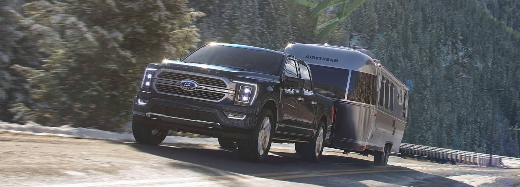 2023 Ford F-150 towing a camper down road