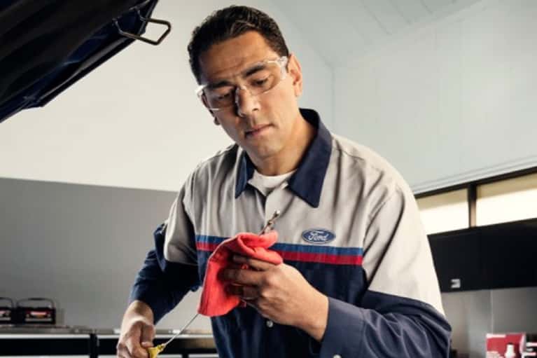 technician inspects engine