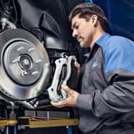 ford serviceman installing brakes