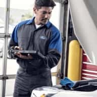 ford technician inspecting engine
