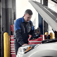 ford-technician-looks-at-engine