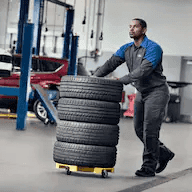 technician-moving-tires