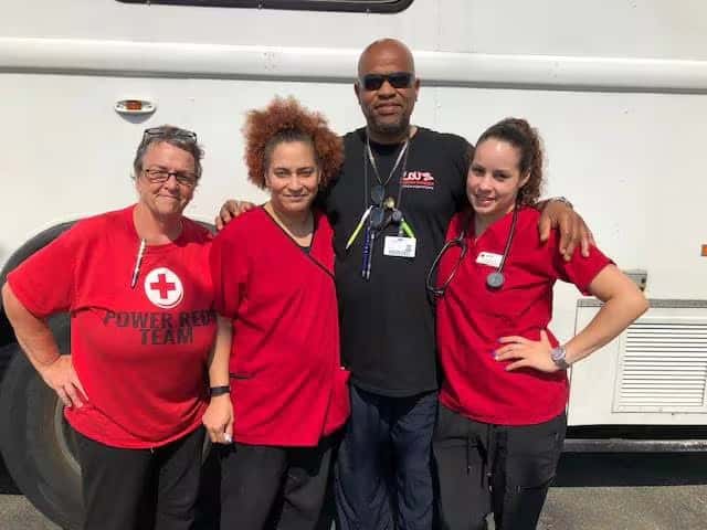 volunteers in red shirts