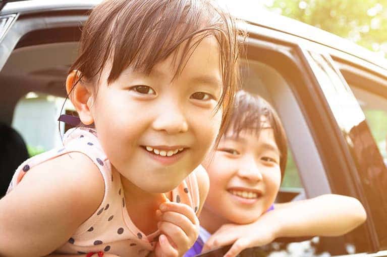 Happy family in a new car