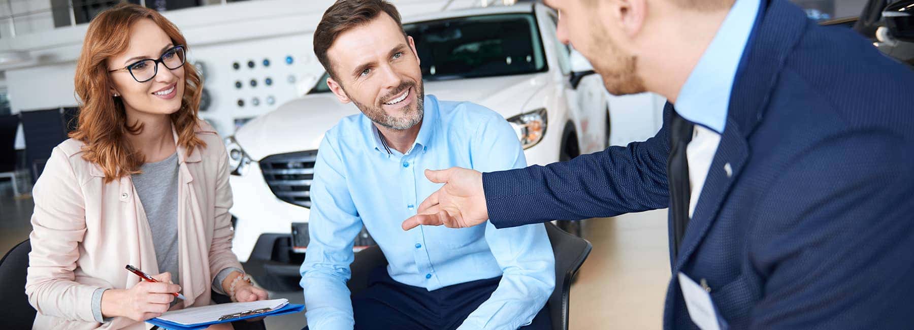 Happy customers buying a car