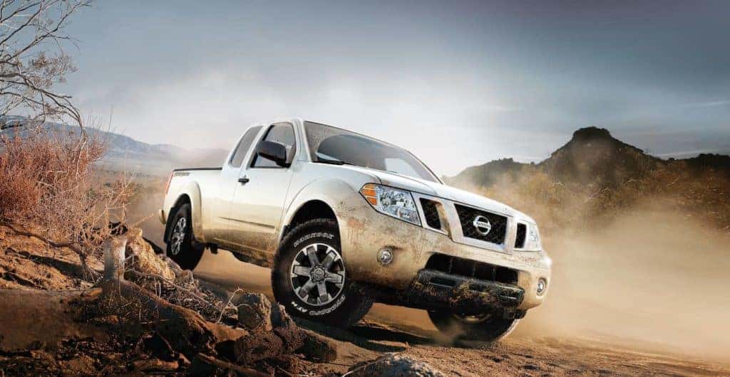 Nissan truck driving through dirt terrain