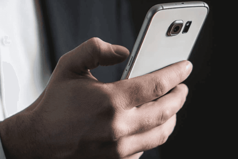 man texts on his smartphone