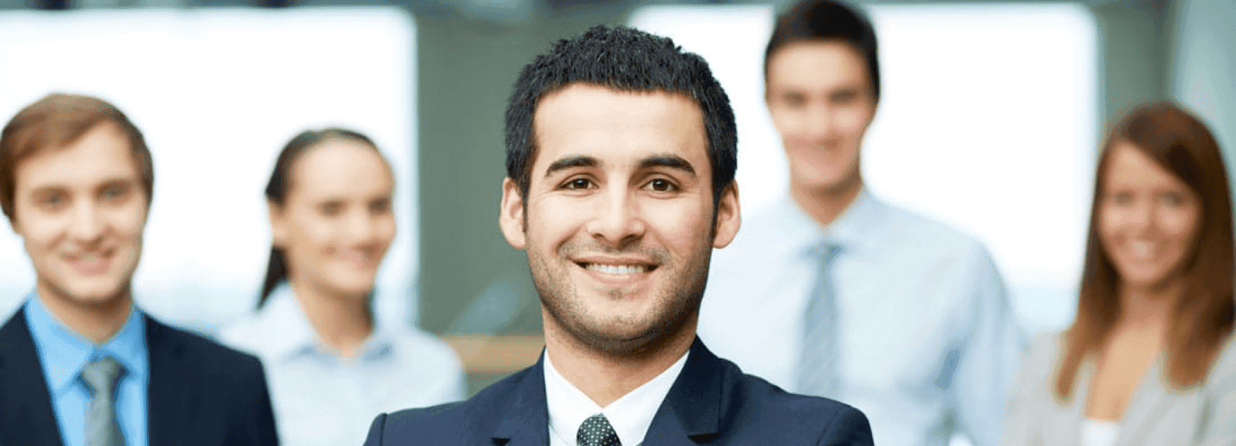 smiling sales team in ties, suits in car showroom