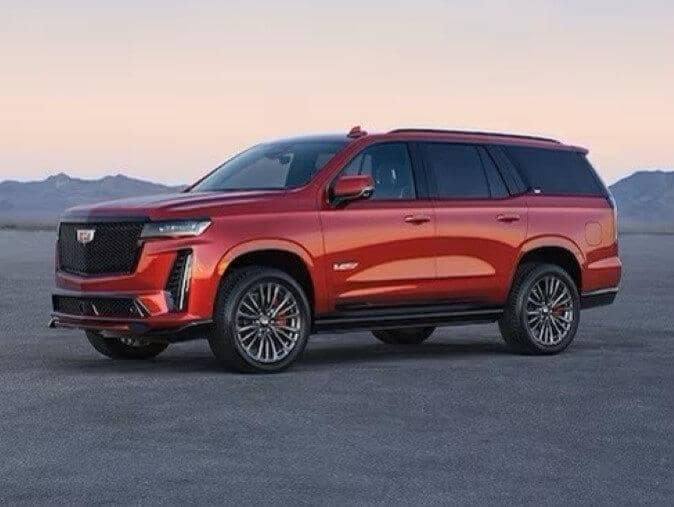 Cadillac Escalade - V-Series orange parked out in the desert during twilight