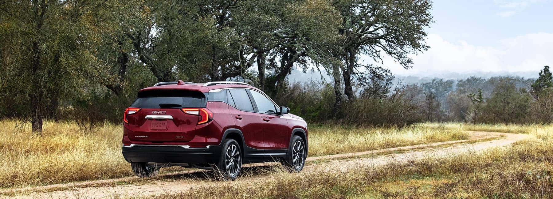 Cayenne Red 2022 GMC Terrain on a grassy road
