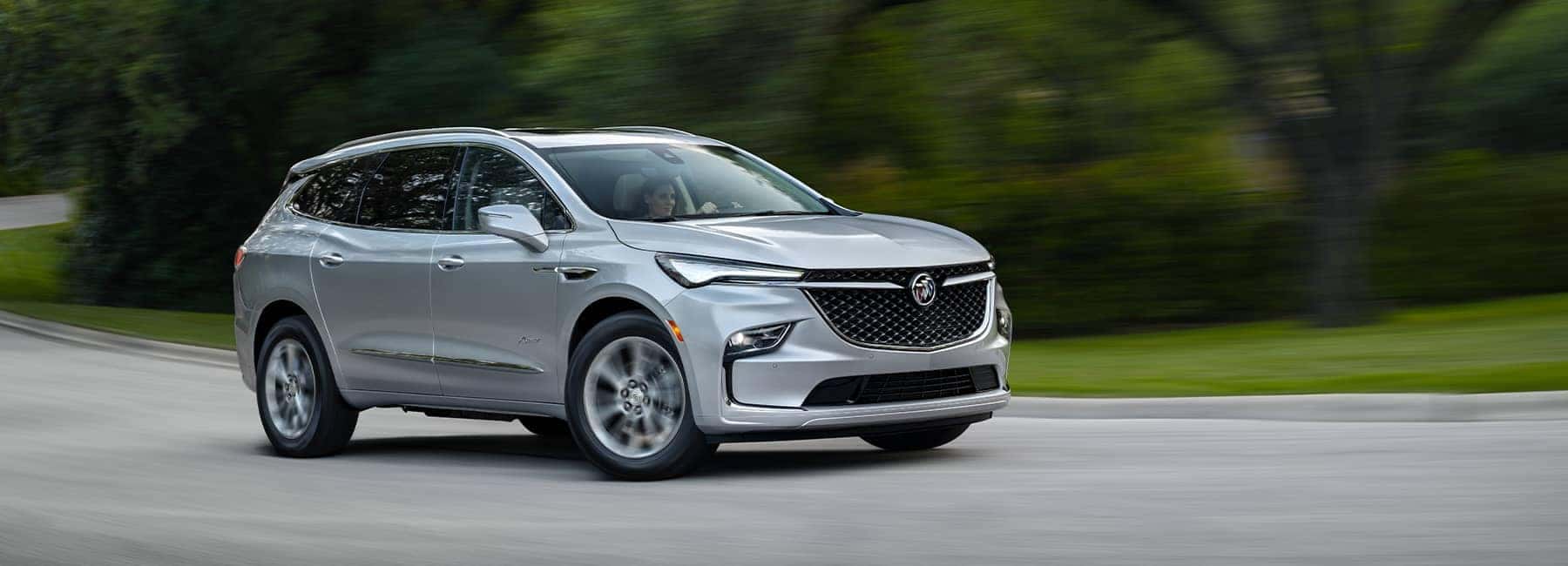 Quicksilver Metallic 2022 Enclave Avenir on a curving road