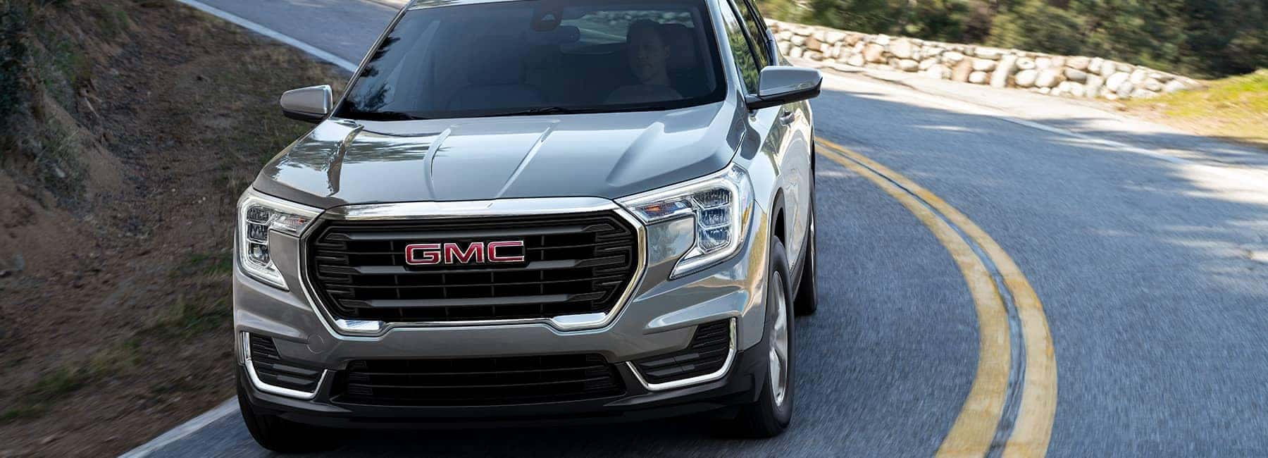 Quicksilver Metallic 2022 GMC Terrain on a curving road