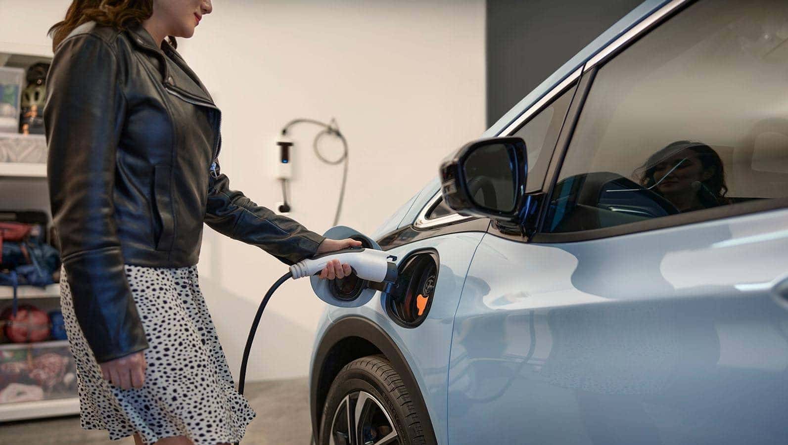 Woman plugging in an EV