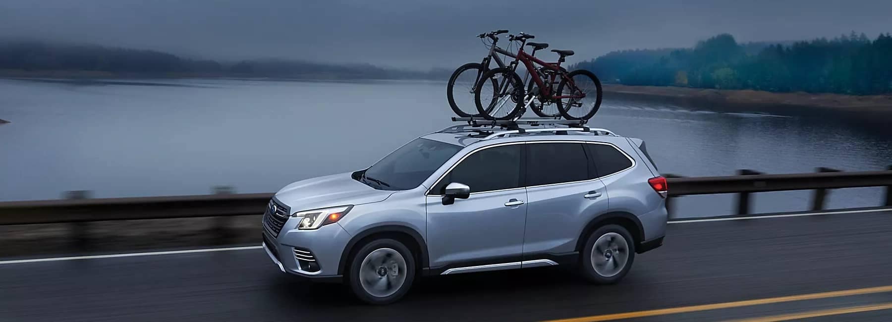 2022 Forester-sideview-cloudy day by dam_lake w_ kayaks-silver