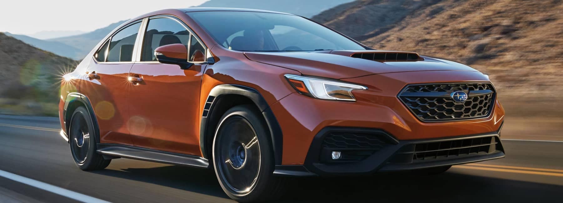 2022 Subaru WRX-closeup 3qview-driving down highway-orange