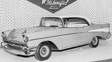 Showroom window display of the new 1957 Chevrolet, the car that would become the icon of an era.