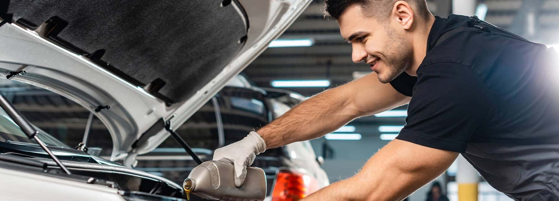 Mechanic-replacing-engine-oil-in-a-vehicle_mobile