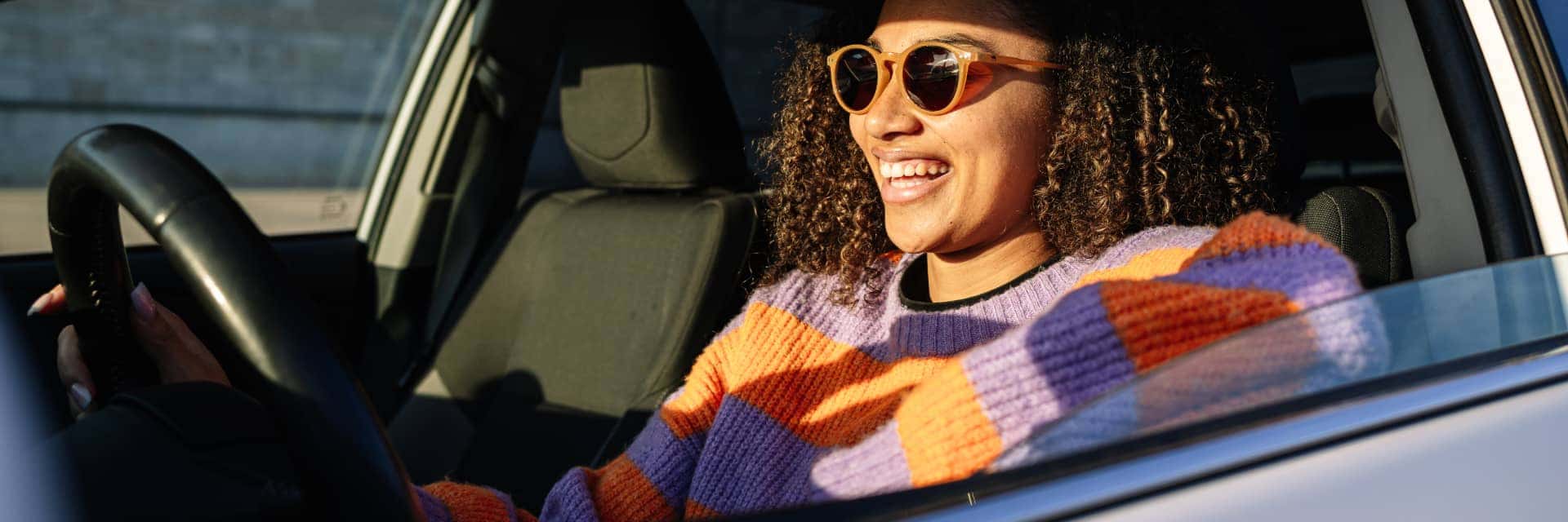 smiling woman driving vehicle
