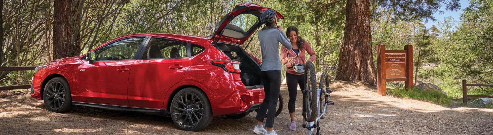 Subaru with a family unloading groceries from the hatchback