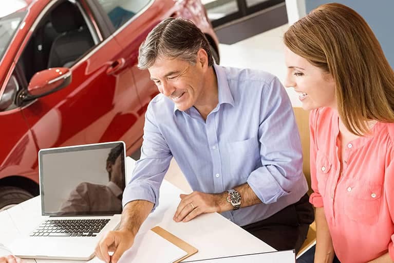 Couple Looking at Financial Documents with Salesman
