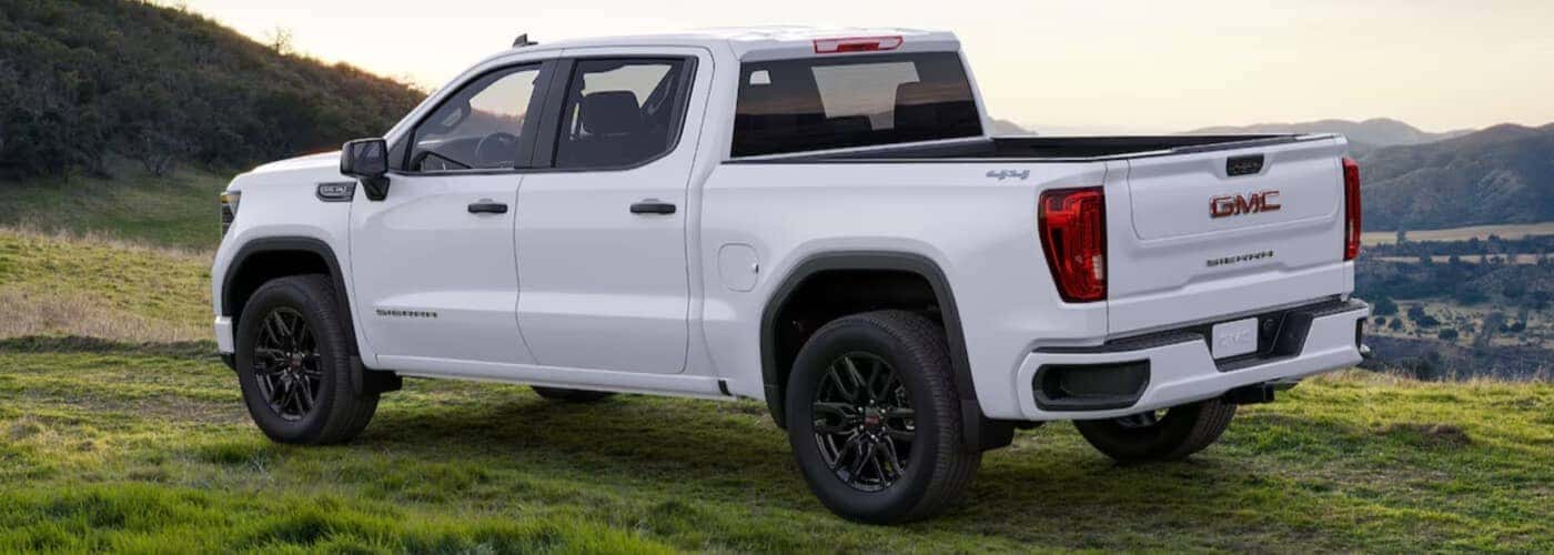 White GMC truck parked in a field