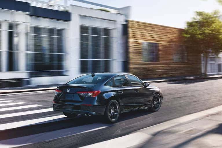 MY24-Black-Honda-Civic-Sedan-driving-through-an-intersection