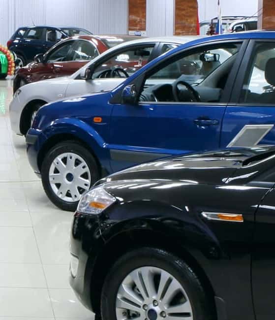 Cars-are-lined-up-in-a-showroom-facing-each-other