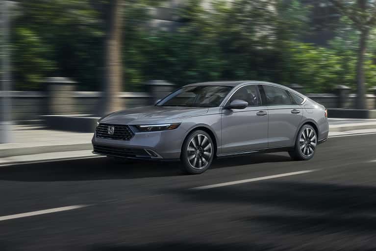 2024-honda-accord-ex-speeding-along-city-street-with-brick-walls-in-background-mobile