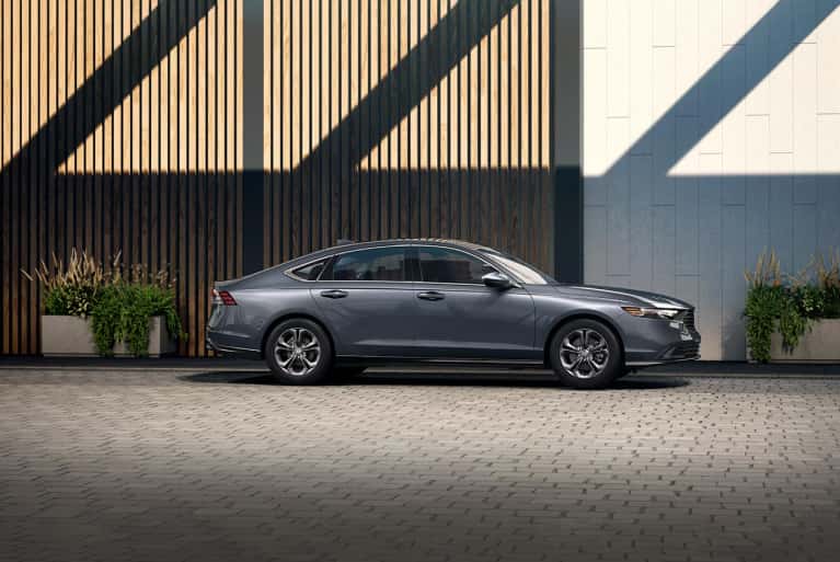 2024-honda-accord-lx-parked-in-front-of-building-with-large-planters-overflowing-with-flowers-mobile