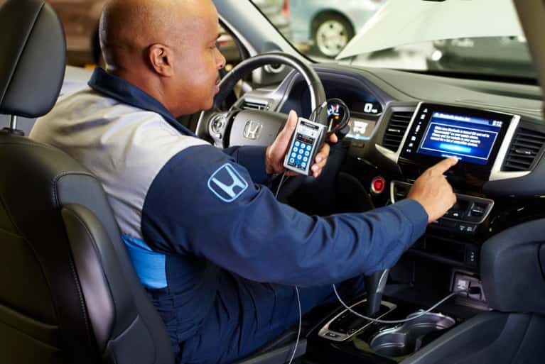Honda-service-technician-working-on-the-interior-LED-screen-mobile